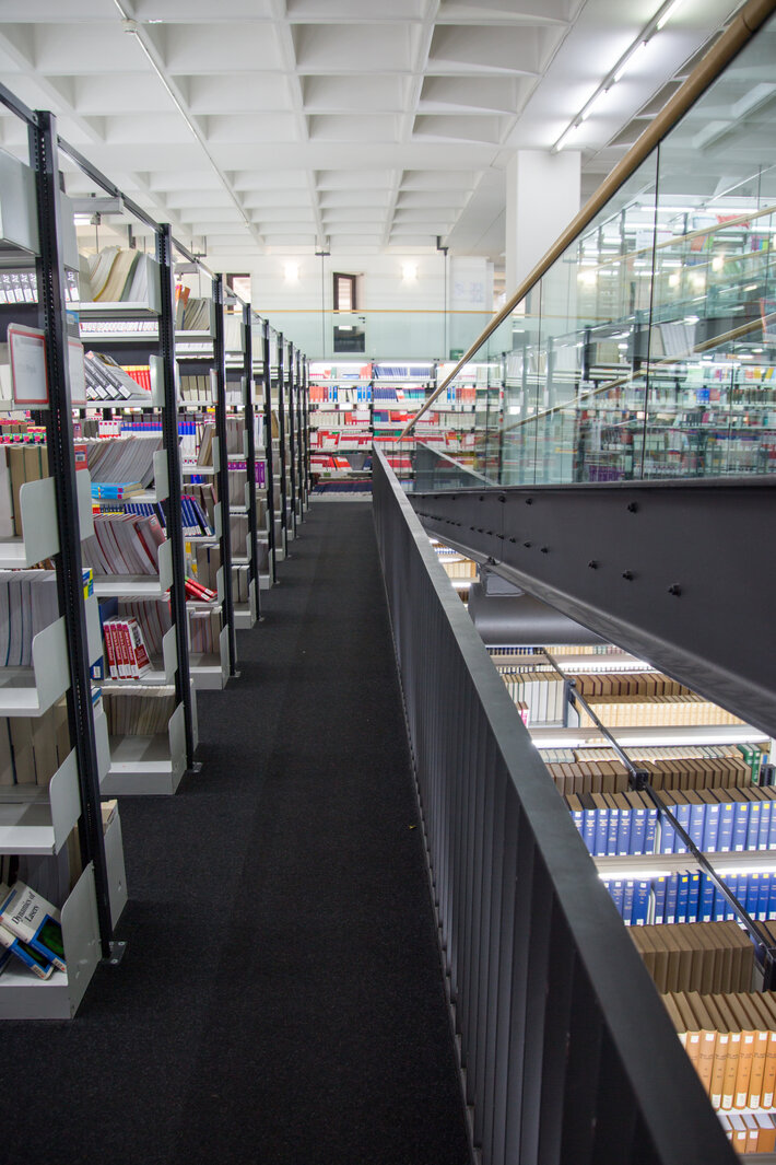 Lange Reihen mit gut indirekt beleuchteten Bücherregalen in der Lehrbuchsammlung an der Universitätsbibliothek Regensburg (öffnet Vergrößerung des Bildes)
